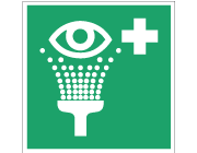 Grön nödskylt med symbol för ögondusch.